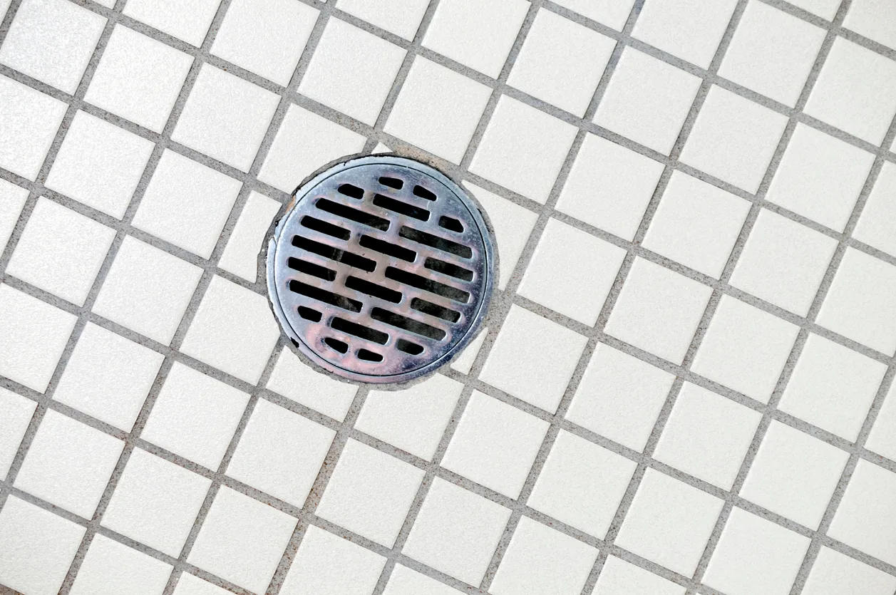 Homeowner investigating a drain odor in a Mesa Arizona home