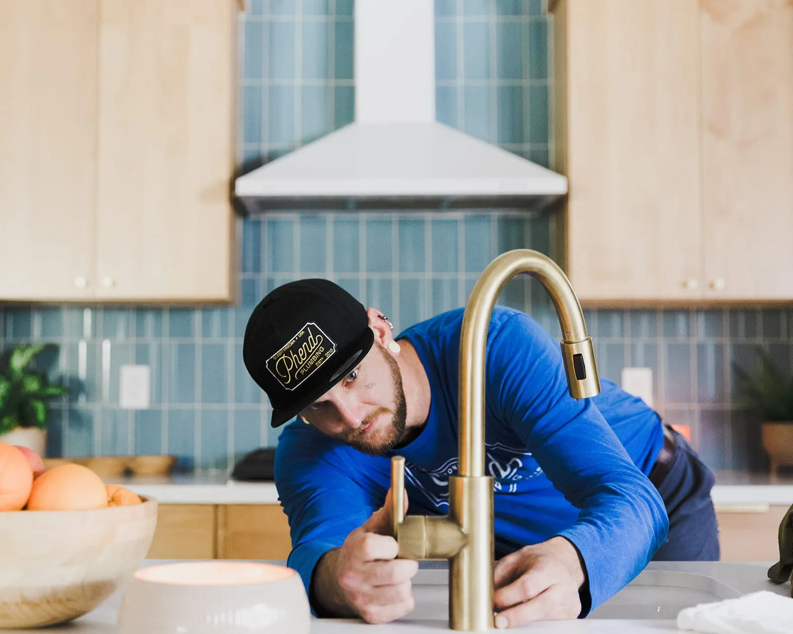 Phend Plumbing technician installing a kitchen faucet in an East Valley home